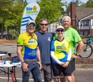 Bike Alpharetta members complete helmet fittings and pumping tires at Greenway Day 2025